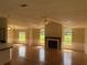 Spacious living room features natural light, a fireplace, and hardwood flooring throughout at 9625 Moore Rd, Lakeland, FL 33809