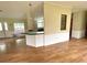Bright living space featuring laminate flooring, a bar counter and entry to the kitchen at 9625 Moore Rd, Lakeland, FL 33809