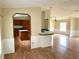 Open floor plan connecting the kitchen to the dining and living areas, featuring laminate flooring at 9625 Moore Rd, Lakeland, FL 33809