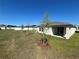 Large backyard with lush green grass and a covered patio perfect for outdoor entertaining at 2242 Majestic Span Ave, Eagle Lake, FL 33839