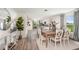 Open-concept dining room with stylish table set and hardwood floors at 2242 Majestic Span Ave, Eagle Lake, FL 33839