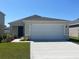 Charming single-story home with a two-car garage and well-maintained front lawn at 2242 Majestic Span Ave, Eagle Lake, FL 33839