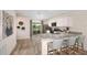Modern kitchen features granite countertops, stainless steel appliances, and breakfast bar seating at 2242 Majestic Span Ave, Eagle Lake, FL 33839