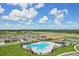 Aerial view highlighting the community pool, surrounding homes, and lush green spaces in a well-maintained neighborhood at 3528 Dahlia Dr, Haines City, FL 33844