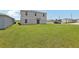 Spacious backyard featuring green grass and a sliding door to the house at 3508 Dahlia Dr, Haines City, FL 33844