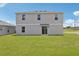 Spacious backyard featuring green grass and a sliding door to the house at 3508 Dahlia Dr, Haines City, FL 33844