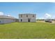 Spacious backyard featuring green grass and a sliding door to the house at 3508 Dahlia Dr, Haines City, FL 33844