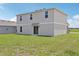 Spacious backyard featuring green grass and a sliding door to the house at 3508 Dahlia Dr, Haines City, FL 33844