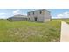 Spacious backyard featuring green grass and a sliding door to the house at 3508 Dahlia Dr, Haines City, FL 33844