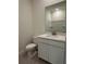 Bathroom with modern vanity, toilet, and neutral color scheme at 6107 Sw 115Th Street Rd, Ocala, FL 34476
