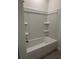 Bathroom featuring a tub with a white surround and built-in shelving at 6107 Sw 115Th Street Rd, Ocala, FL 34476