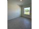 Bedroom featuring tile floors and natural light from a window overlooking the yard at 6107 Sw 115Th Street Rd, Ocala, FL 34476