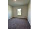 Bedroom featuring carpet and natural light from a window overlooking the yard at 6107 Sw 115Th Street Rd, Ocala, FL 34476