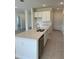 Kitchen island with stainless steel dishwasher, sink, and quartz countertops at 6107 Sw 115Th Street Rd, Ocala, FL 34476