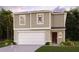 Two-story house with a neutral color scheme, two-car garage, and landscaping at 1005 Ambleside Dr, Haines City, FL 33844