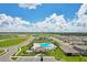 Aerial view of a community pool and the surrounding neighborhood at 3429 Dahlia Dr, Haines City, FL 33844