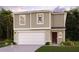 Two-story house with a two-car garage and landscaping at 1013 Ambleside Dr, Haines City, FL 33844