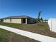 View of the back of the house from sidewalk with sliding glass door to covered porch at 2203 Majestic Span Ave, Eagle Lake, FL 33839