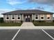 Exterior of community clubhouse featuring manicured landscaping, ample parking, and inviting entrance at 2362 Aquiline Nest St, Eagle Lake, FL 33839