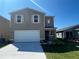 Charming two-story home with a two-car garage, manicured lawn, and inviting front entrance at 2362 Aquiline Nest St, Eagle Lake, FL 33839