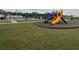 A view of a community playground featuring a colorful slide and climbing structure, perfect for recreation at 2366 Aquiline Nest St, Eagle Lake, FL 33839