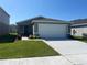 Charming single-story home featuring a two-car garage, neat landscaping, and a well-maintained lawn at 2366 Aquiline Nest St, Eagle Lake, FL 33839