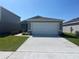 Charming single-story home featuring a two-car garage, neat landscaping, and a well-maintained lawn at 2366 Aquiline Nest St, Eagle Lake, FL 33839