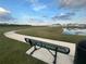 Scenic walking path with pond views and bench seating in this lovely community at 2366 Aquiline Nest St, Eagle Lake, FL 33839
