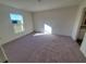 Spacious bedroom with carpeted floor and large window at 13012 Se 53Rd Ave, Belleview, FL 34420