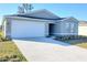 New single-story home with attached garage and landscaping at 13012 Se 53Rd Ave, Belleview, FL 34420