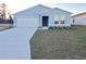 New single-story home with attached garage and landscaped front yard at 12966 Se 53Rd Ave, Belleview, FL 34420