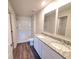 Elegant bathroom with double sinks, granite countertops, and a spacious walk-in shower at 2408 Nw 22Nd Ct, Ocala, FL 34475