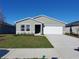 Charming single-story home with a well-maintained lawn and a two-car garage at 2408 Nw 22Nd Ct, Ocala, FL 34475