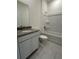 Bright bathroom featuring a single sink vanity and a shower-tub combination at 5530 Sw 103Rd St Rd, Ocala, FL 34476