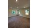 This spacious bedroom is illuminated by natural light, enhancing the plush carpeting at 5530 Sw 103Rd St Rd, Ocala, FL 34476