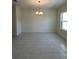 This dining room boasts modern tile floors and a contemporary chandelier above at 5530 Sw 103Rd St Rd, Ocala, FL 34476