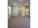 A room with carpet leads to a hallway with carpet, and doorways to other rooms at 5530 Sw 103Rd St Rd, Ocala, FL 34476