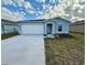 New single-story home with attached garage and landscaping at 1643 Texas Ave, Sumterville, FL 33585