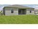 The home has a simple backyard with a blank canvas that is awaiting your custom design at 4323 Periwinkle Pl, Lake Hamilton, FL 33851