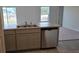 Kitchen with island, stainless steel dishwasher, and gray cabinets at 1807 Don Pl, Poinciana, FL 34759