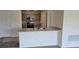 Kitchen boasts a breakfast bar, stainless steel appliances, and gray cabinets at 1807 Don Pl, Poinciana, FL 34759