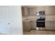 Modern kitchen with stainless steel appliances and gray cabinets at 1807 Don Pl, Poinciana, FL 34759