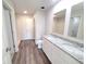 Modern bathroom with double vanity, granite countertop, white cabinets, and walk-in shower at 2491 Nw 23Rd Ave, Ocala, FL 34475