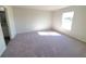 Neutral bedroom with plush carpeting, bright natural light, and a doorway to the en-suite bathroom at 2491 Nw 23Rd Ave, Ocala, FL 34475