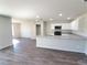 Open-concept kitchen featuring granite countertops, stainless steel appliances, and modern gray flooring at 2491 Nw 23Rd Ave, Ocala, FL 34475