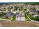 Aerial view showcasing the house's backyard with a patio, and a neighborhood view at 30120 Hackney Loop, Mount Dora, FL 32757