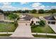 Aerial view of a two-story house with a three-car garage and landscaped yard at 30120 Hackney Loop, Mount Dora, FL 32757