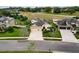 An aerial view showcasing a house with solar panels, a three-car garage, and a well-maintained lawn at 30120 Hackney Loop, Mount Dora, FL 32757