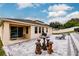 Landscaped backyard with patio, grill, and seating area at 30120 Hackney Loop, Mount Dora, FL 32757