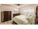 Light and airy bedroom with a queen bed, dresser, and large windows at 30120 Hackney Loop, Mount Dora, FL 32757
